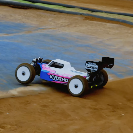 Kyosho Inferno MP11e review showing 1/8 electric buggy racing on dirt track