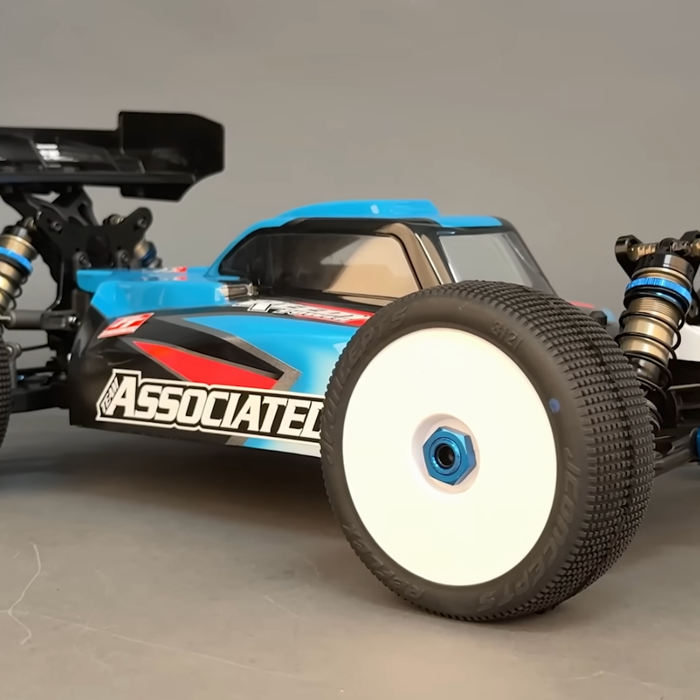 Team Associated RC8B4.2e 1/8 scale electric off-road buggy with blue and black body on studio background