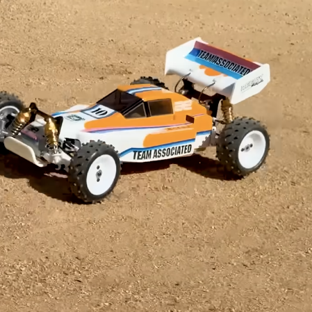 Team Associated YZ10 Classic 1/10 4WD electric buggy on dirt track, inspired by the Yokomo YZ10 IFMAR-era platform