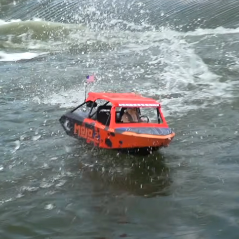 Pro Boat 1/6 Jetstream Shreddy RC jet boat running through a shallow rocky creek