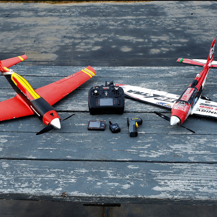 Durafly EFXtra vs Eflite V900 RC plane comparison setup with both aircraft on a table before flight