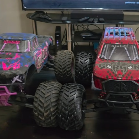 ARRMA GORGON 223S brushless 2WD monster truck beside QUAKE 223S showing QUAKE DNA and different body style
