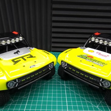 FMS FSC18 Ford Bronco RTR EB brushed vs brushless comparison with two mini Bronco trucks side by side