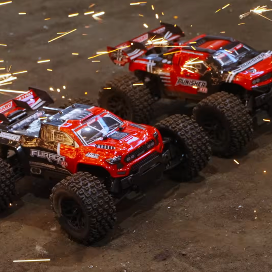 Team Corally Furago XD and Punisher XD mini bashers racing side by side with sparks in an XD2S chassis review