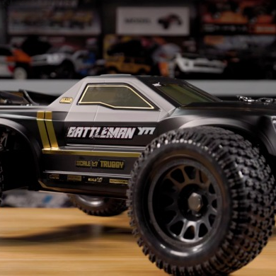 YIKONG BATTLEMAN YT7 PRO 1/7 scale racing truggy shown in a workshop setting, highlighting its wide stance and off-road chassis design