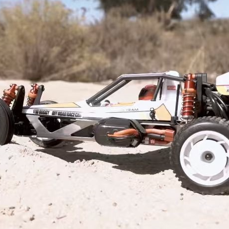 Kyosho Ultima 1/10 Vintage Buggy re-release running in desert terrain, showing aluminum chassis and red oil shocks