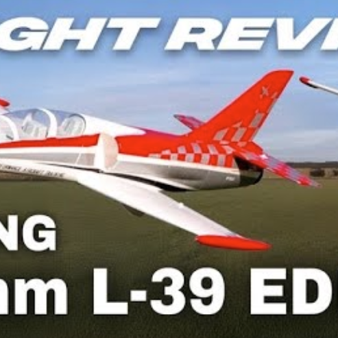 HobbyKing L39 Albatros 64mm EDF jet flying low over grass field, inspired by the Aero L 39 Albatros trainer aircraft