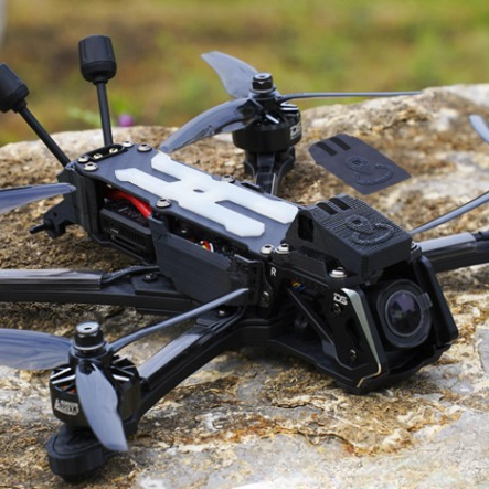 DeepSpace Seeker 5 FPV drone with DJI O4 Pro mounted outdoors on a rock, showing deadcat frame and 5-inch freestyle setup