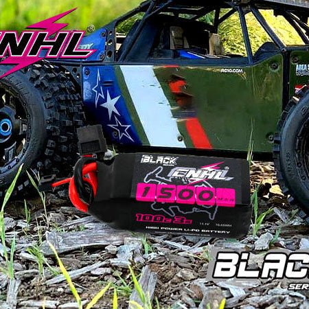 A CNHL 7500mAh 100C Black Series LiPo battery resting on the ground in front of a large off-road RC truck.