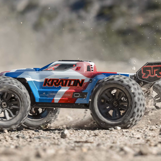 ARRMA Kraton 6S V6 1/8 scale 4WD speed monster truck kicking up dirt during high-speed run, showcasing new blue and red body design