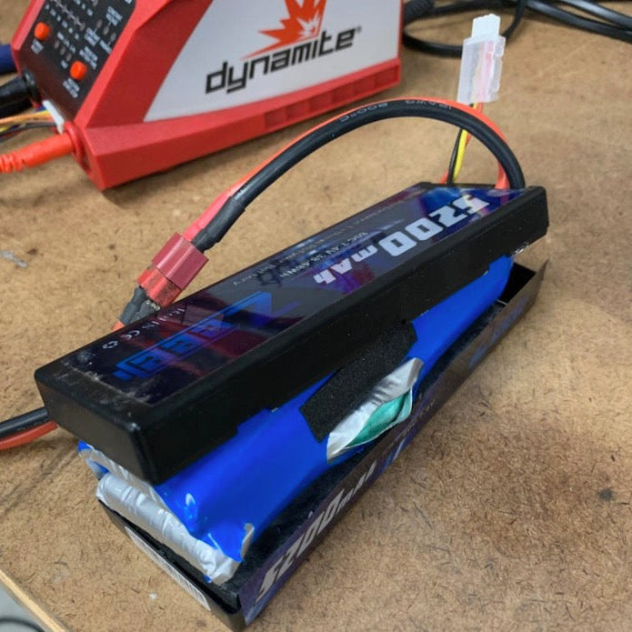 RC hobby workbench with old LiPo battery ready for disposal