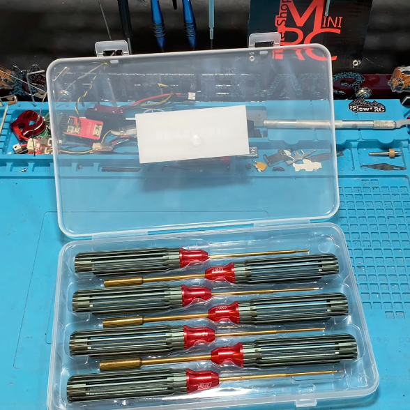 RC car tool setup on workbench with hex drivers and LiPo battery
