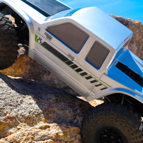 Axial SCX10 III Coyote 1/10 RTR Brushed Rock Crawler in silver body on rocky trail