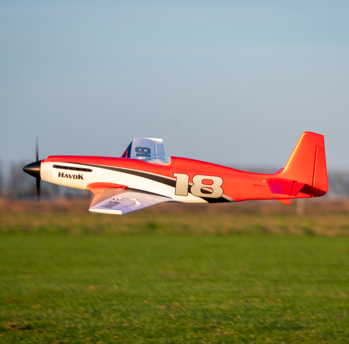 CNHL Havok 1000mm 4S RC plane flying low over grass field