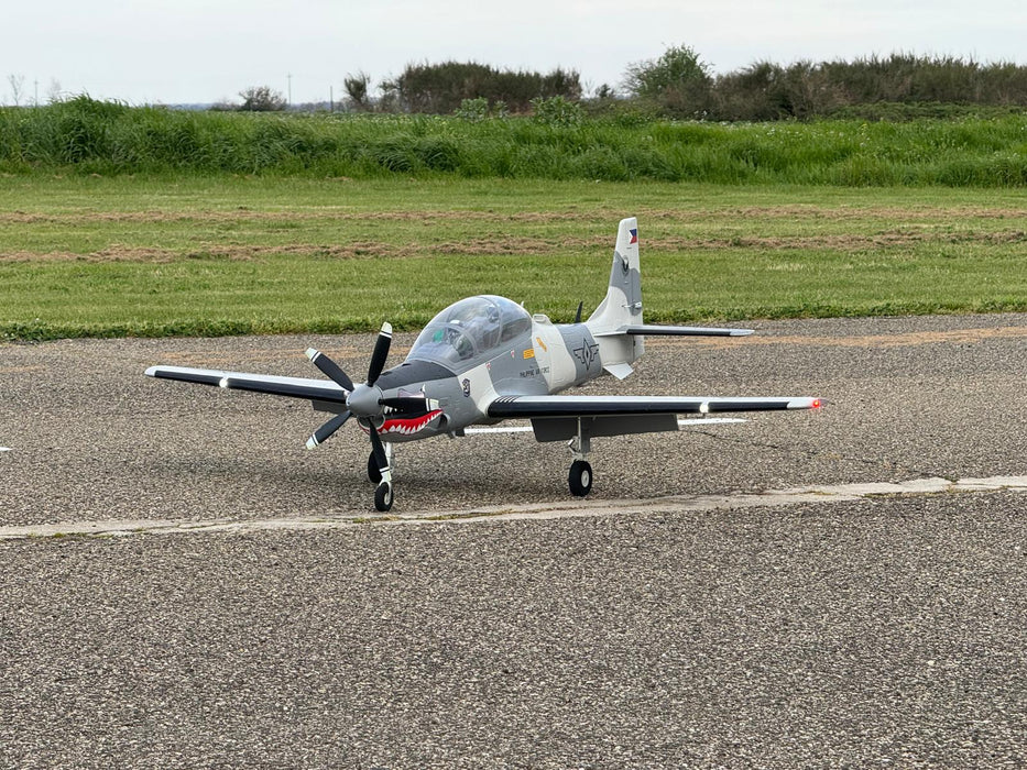 CNHL Super Tucano 1600mm RC warbird taxiing on runway before takeoff, showcasing scale details and tricycle landing gear.