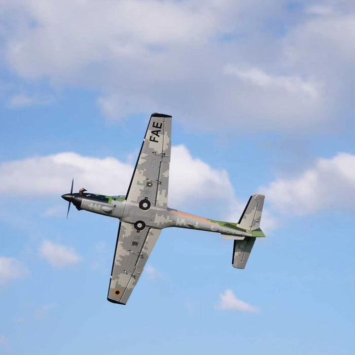 Underside view of CNHL Super Tucano V2 1600mm RC plane in flight