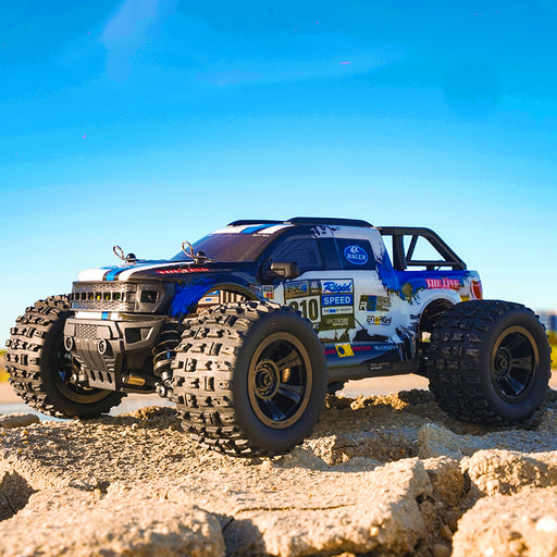 Blue SCY 18102 brushed RC monster truck jumping over terrain