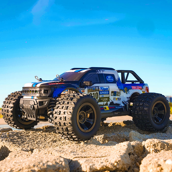 Blue SCY 18102 brushed RC monster truck jumping over terrain